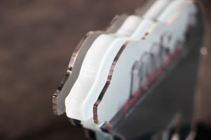 Close up photo of silver bear-shaped plaque