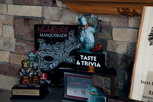 Collection of award plaques sit together on table